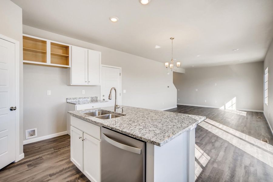 Kitchen island and great room of the Fraser floor plan by Century Communities