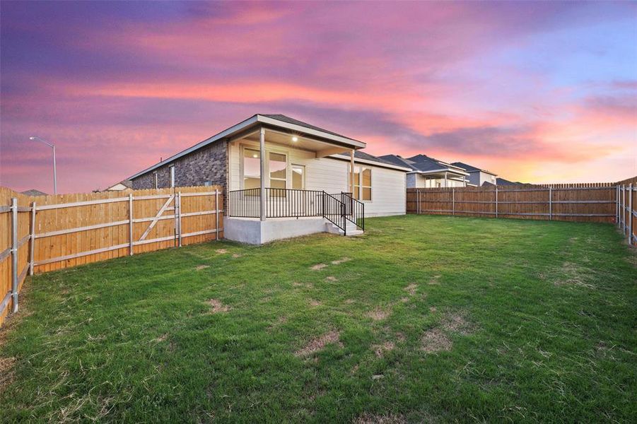 Enjoy gentle breezes on the covered patio overlooking the fenced back yard.