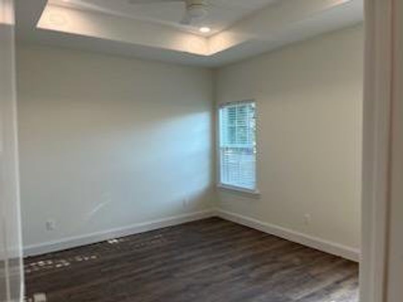 Unfurnished room featuring dark hardwood / wood-style flooring