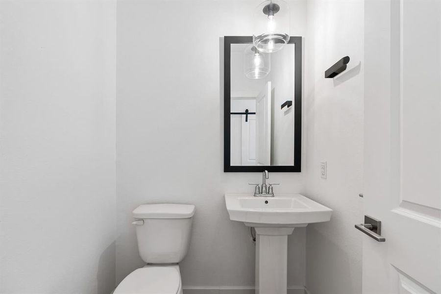 Half bath for convenience in hallway.