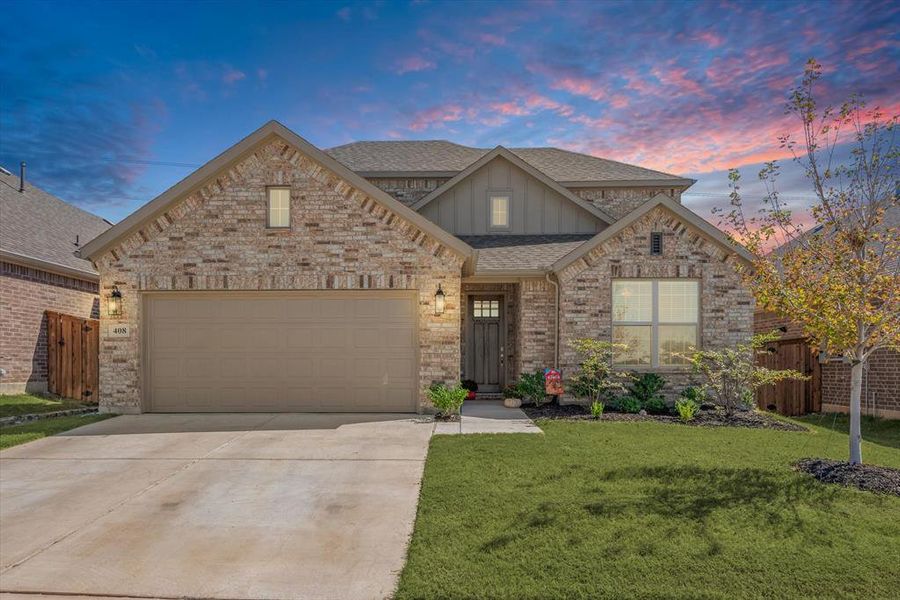 Front of home showcasing 8' door and landscaping