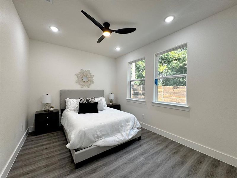 Bedroom featuring dark wood-type flooring and ceiling fan