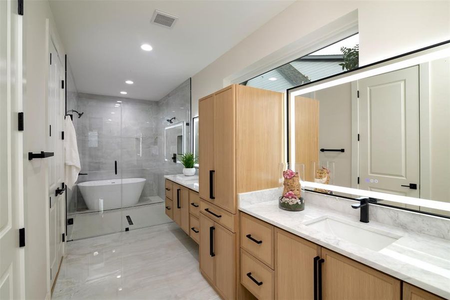 Bathroom with vanity and separate shower and tub