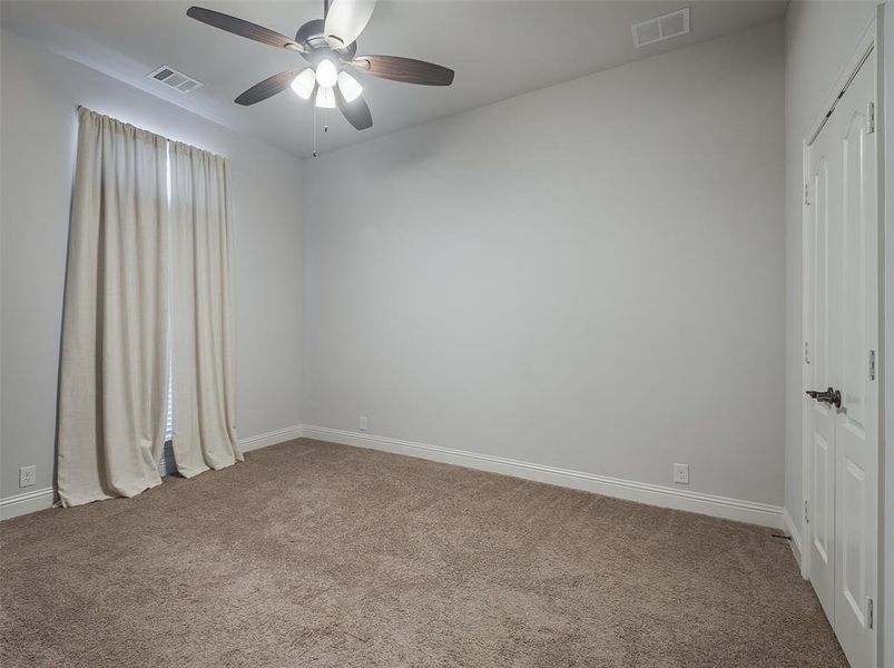 Spare room featuring ceiling fan and carpet floors