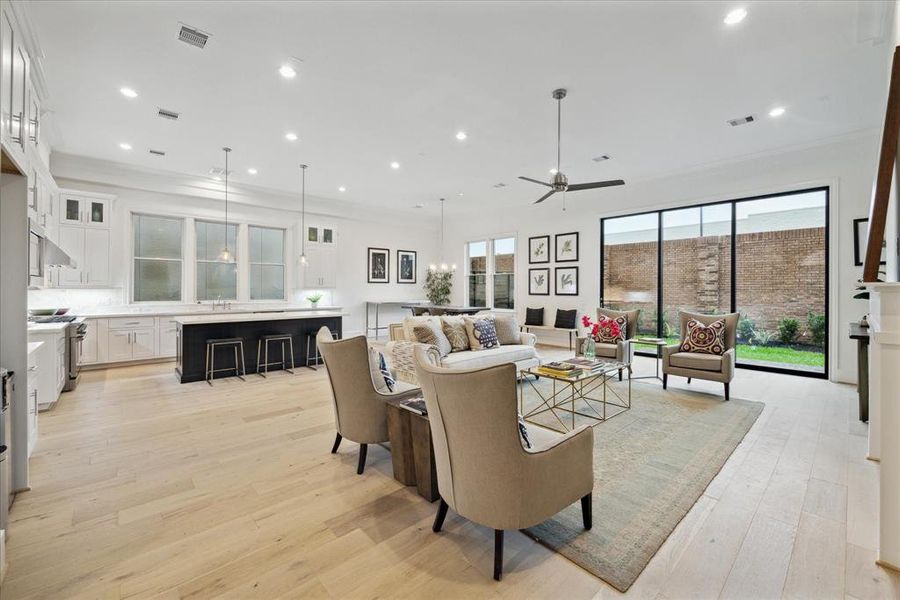 The living room opens to the kitchen and 10' sliding stacking doors to your private fenced-in back yard