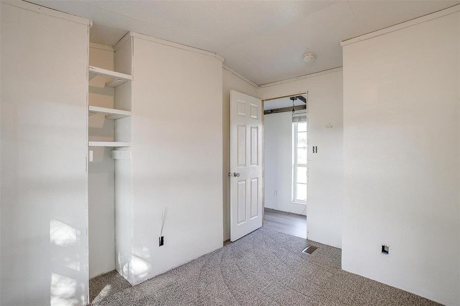 Unfurnished bedroom featuring carpet and vaulted ceiling