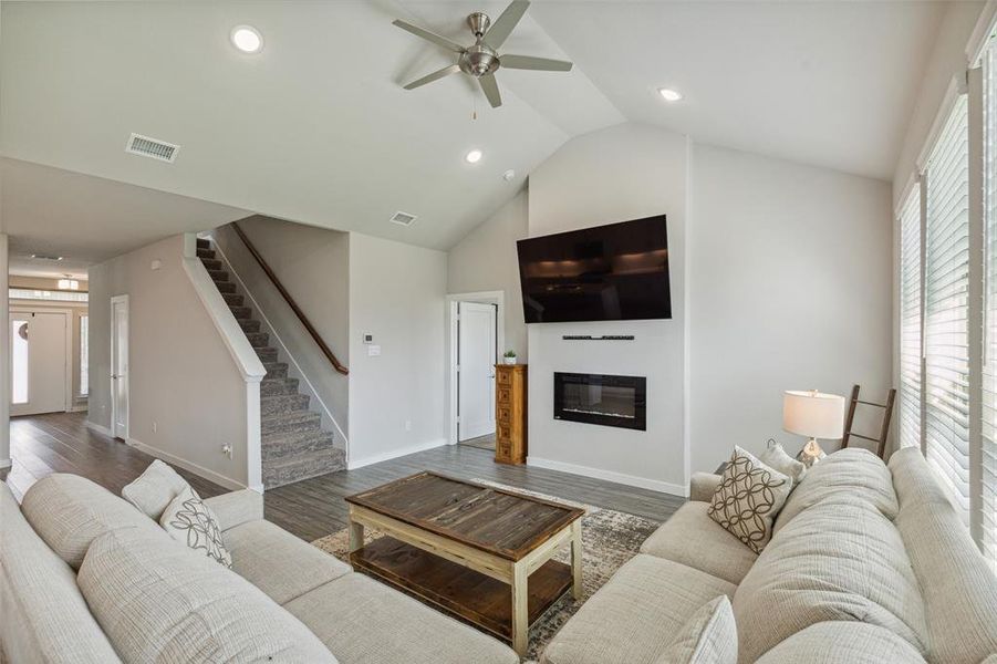 living space with vaulted ceilings, great for entertaining guests around the fireplace!