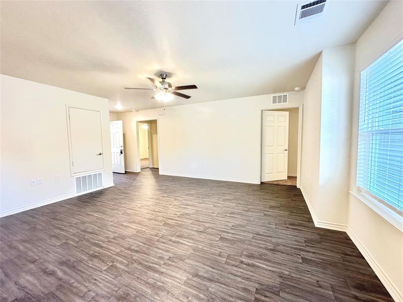 Empty room featuring dark hardwood / wood-style floors and ceiling fan