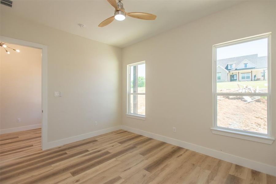 Empty room with light wood-type flooring and ceiling fan