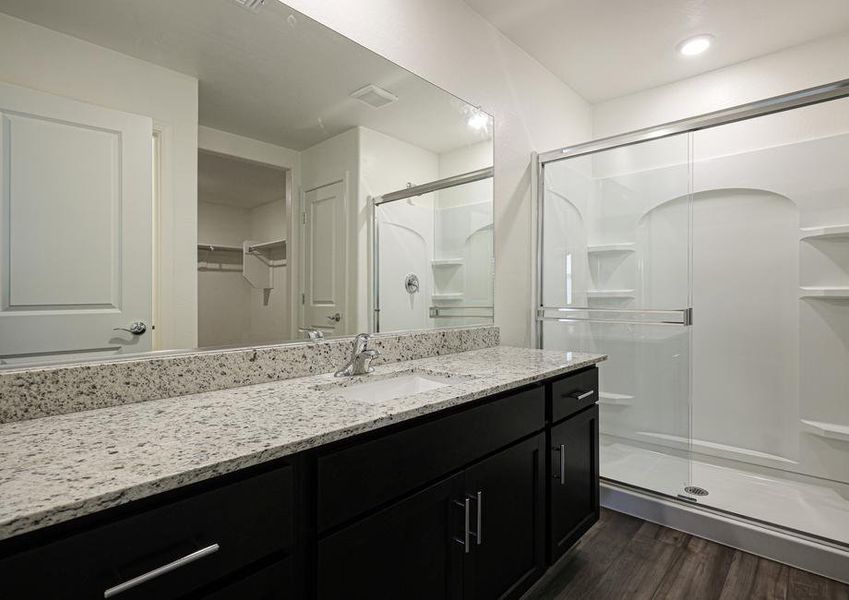 The master bath has a spacious, glass-enclosed shower.