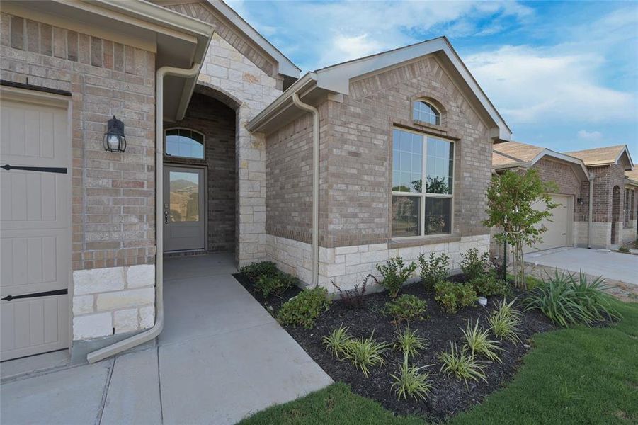 Covered front Porch & landscaped yard