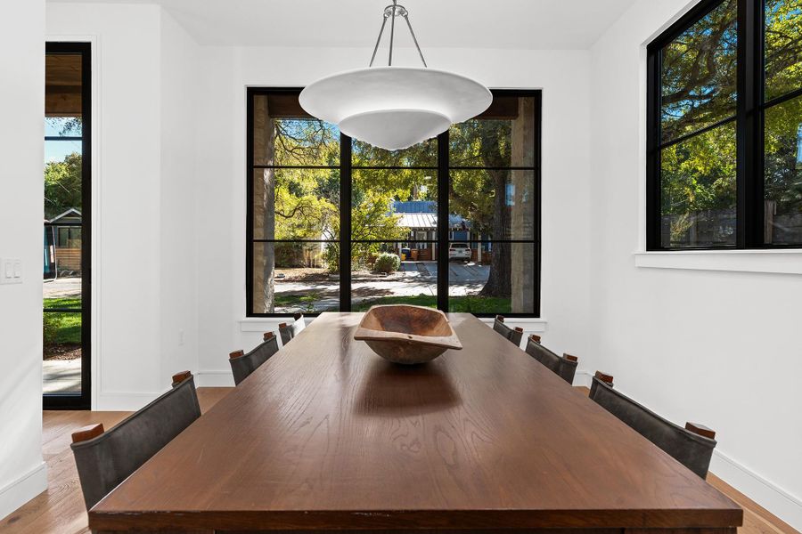 The beautiful dining chandelier is centered in the dining room window, welcoming guests to your table both inside and out.