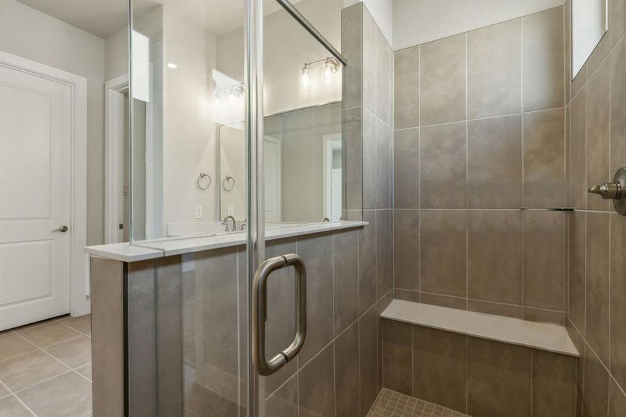 Bathroom with walk in shower and tile patterned floors