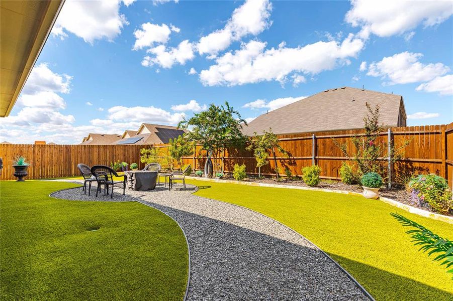 View of yard with a patio and an outdoor fire pit