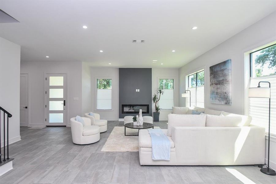 Built in modern fireplace is sure to be a conversation starter in this spacious living/dining area