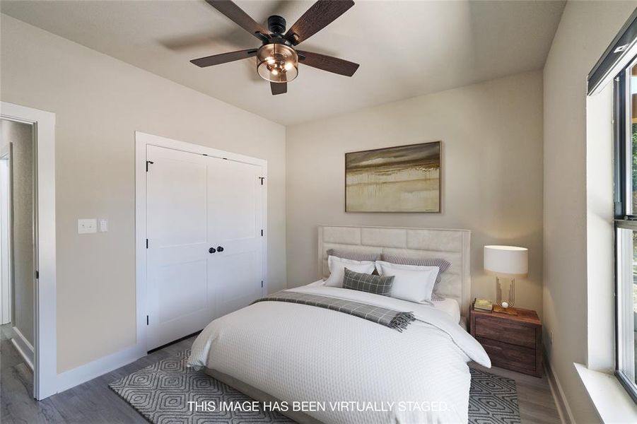 Bedroom with a closet, wood-type flooring, and ceiling fan