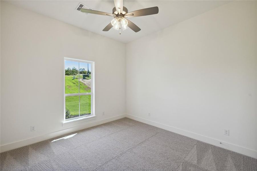 Unfurnished room with ceiling fan and carpet flooring