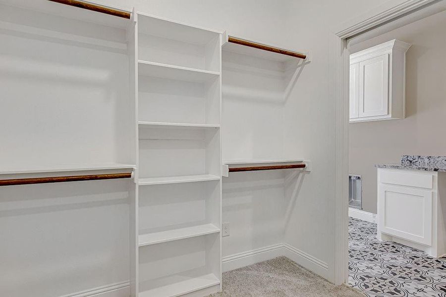 Spacious closet with light tile patterned floors