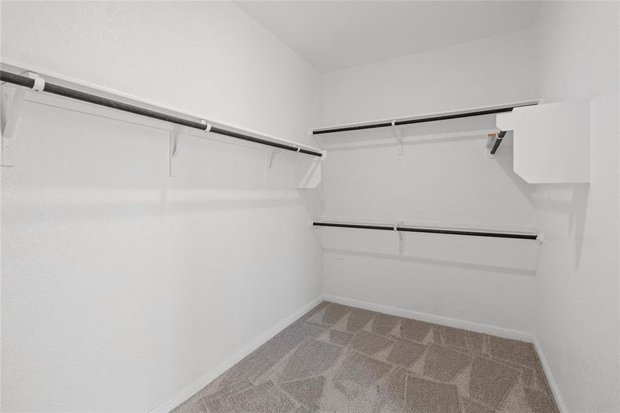 Primary walk-in closet with ALOT of space.