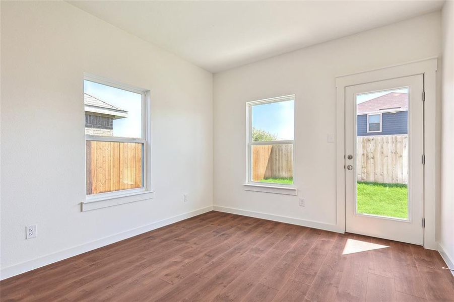 Empty room with hardwood / wood-style floors