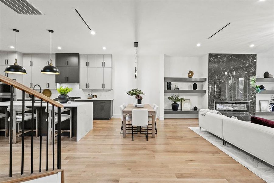 Living room with light hardwood / wood-style floors and a premium fireplace