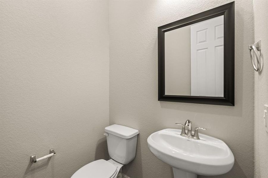 This charming home features a beautifully appointed half bath adjacent to the family room, perfect for welcoming guests and adding convenience to your daily life.