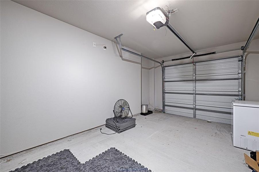 Garage featuring a garage door opener