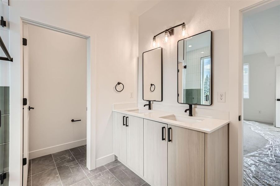 Primary ensuite with double vanity, designer finishes, and quartz countertops