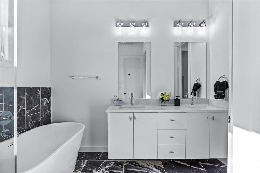 Primary Bathroom with a freestanding tub and vanity