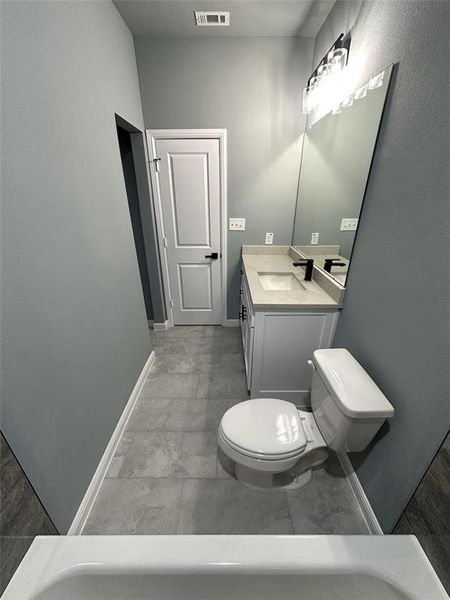 Bathroom featuring vanity and toilet