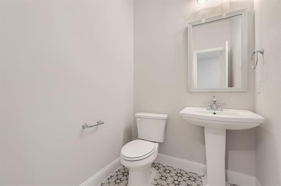 Bathroom featuring tile patterned flooring and toilet