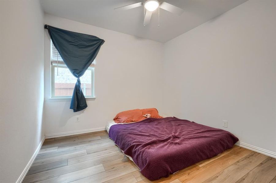 Bedroom featuring light hardwood / wood-style flooring and ceiling fan