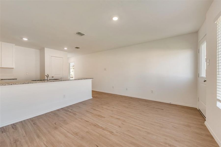 Unfurnished living room with light hardwood / wood-style floors