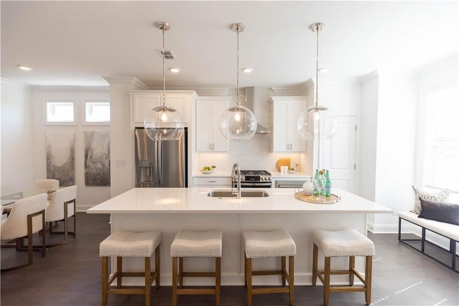 The Kitchen opens up to the dining area. **Photos of model house and not of actual home - Photos for representation purposes only **