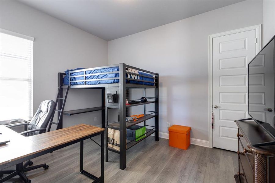 Bedroom with hardwood / wood-style flooring