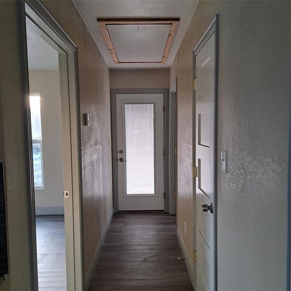 Hallway featuring dark wood-type flooring