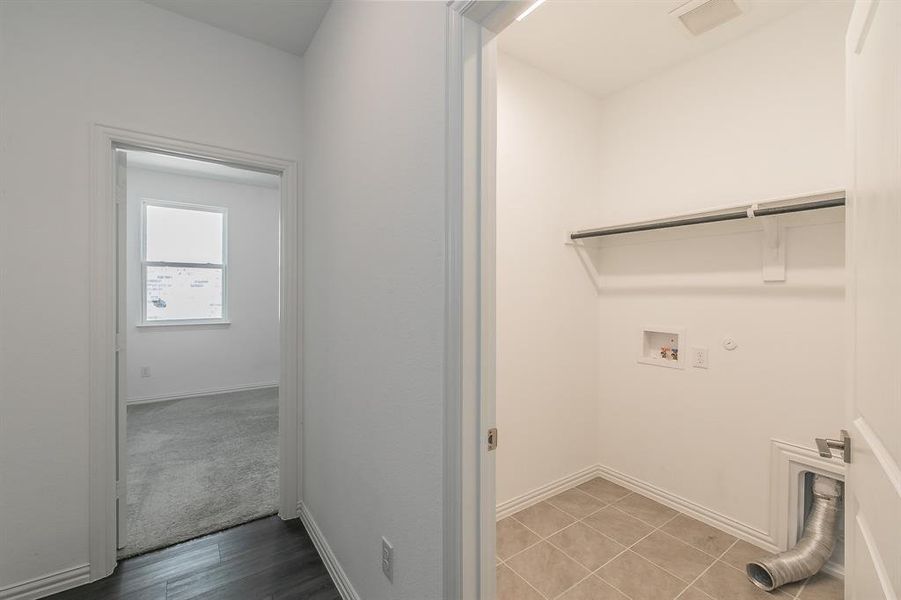 Laundry room featuring washer hookup, gas dryer hookup, and light hardwood / wood-style flooring