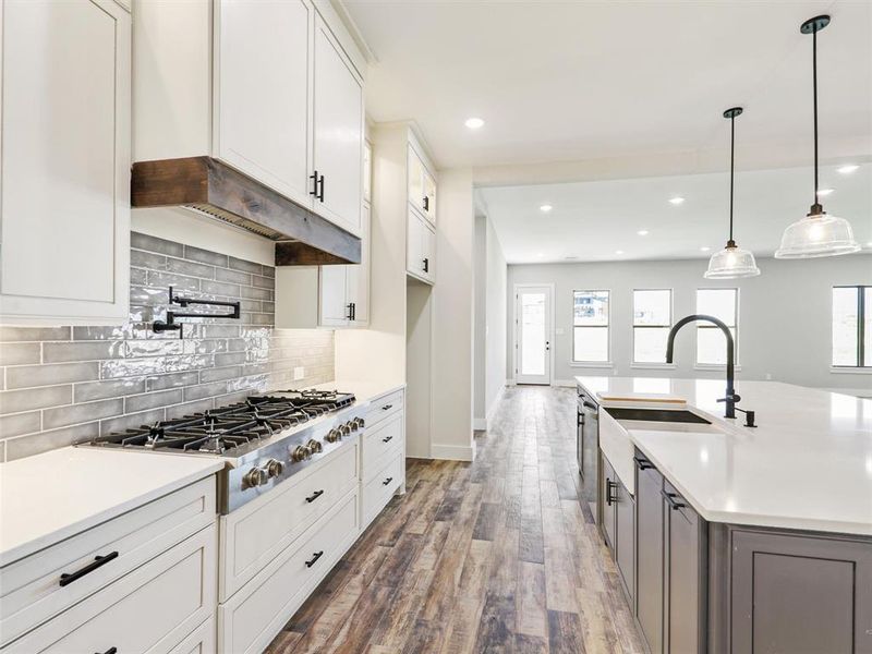 The combination of gas cooking and the wall-mounted faucet makes this kitchen a culinary dream come true.