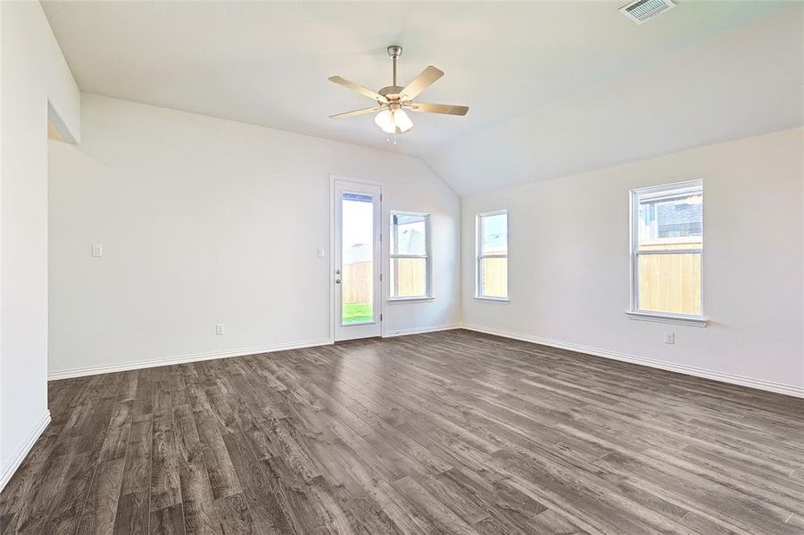 Unfurnished room with lofted ceiling, ceiling fan, and dark hardwood / wood-style floors