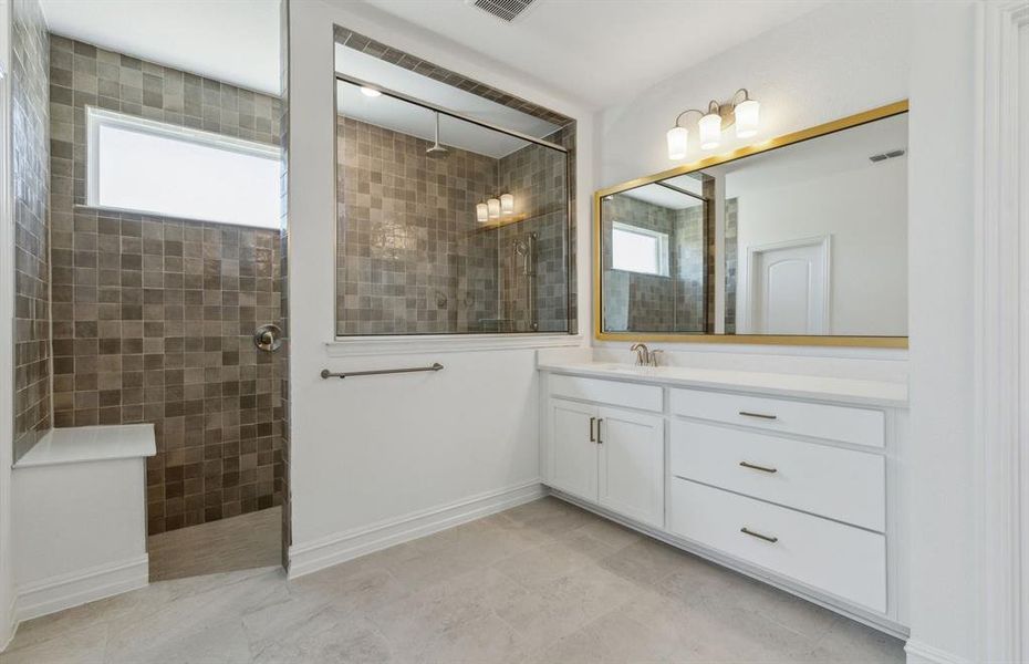 Spacious owner's bathroom with dual vanity and oversized shower *real home pictured