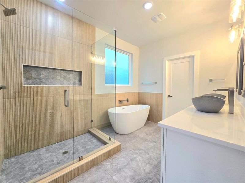 Bathroom featuring tile patterned flooring, plus walk in shower, and vanity