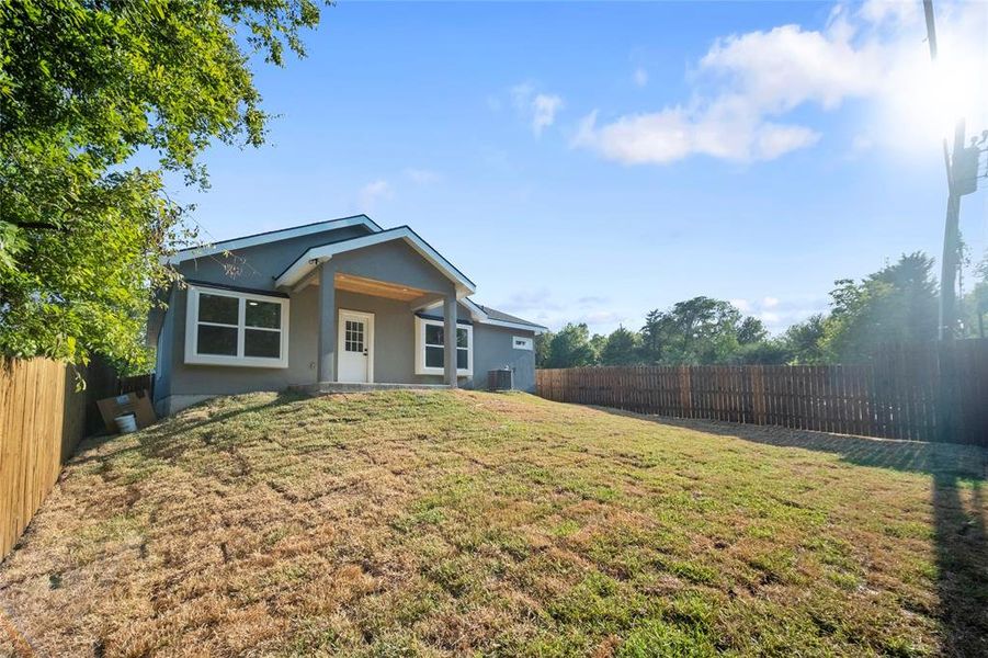 Single story home with a front yard and central AC