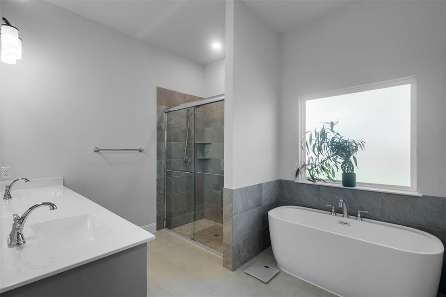 Bathroom with independent shower and bath, vanity, and tile patterned floors