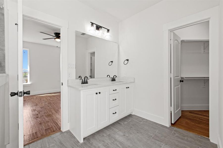 Bathroom featuring vanity, wood-type flooring, and ceiling fan