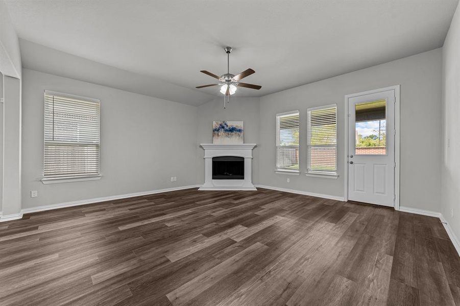 Unfurnished living room with lofted ceiling, ceiling fan, and dark hardwood / wood-style floors