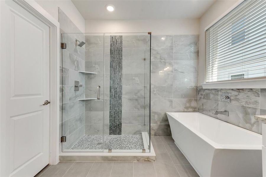 Bathroom with tile patterned flooring and plus walk in shower