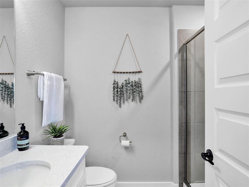 Upstairs bathroom with quartz counters and walk in shower