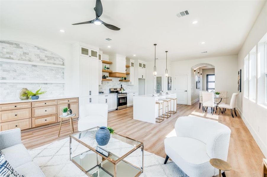 Living room with sink, light wood-type flooring, and ceiling fan