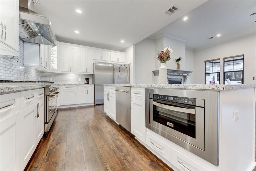 Noticing the 32" freezer & 32" fridge, and the built-in microwave placed within everyone's reach.