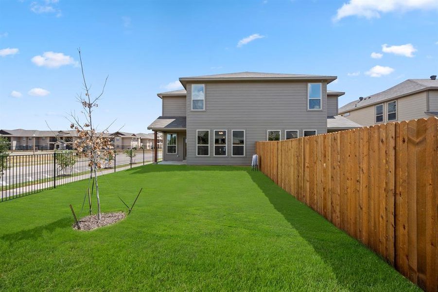 Rear view of house with a yard